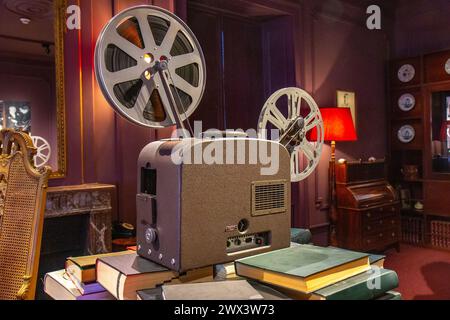 Vintage old projector with tape in the dark room in the house Stock Photo
