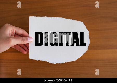 Digital Digital. Woman hand holds a piece of paper with a note, digital. Binary, electronic, automated, integrated, device, processor. note B1983 digi Stock Photo