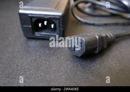 Power cord and plug for electronic devices. Focused on female one. Stock Photo