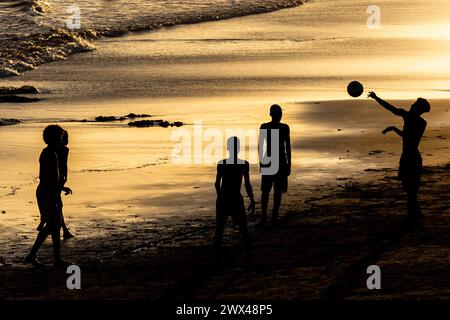 Salvador, Bahia, Brazil - February 14, 2019: Young people, in silhouette, are seen playing beach soccer on Ondina beach in Salvador, Bahia. Stock Photo