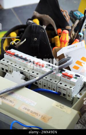 Electricians tools and old fuse box Stock Photo