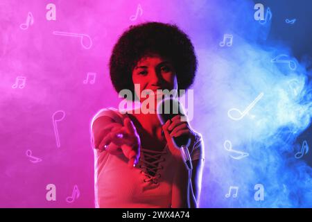 Singer's performance poster. Woman with microphone on bright background Stock Photo