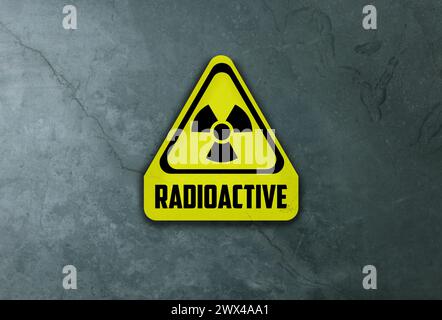 Radioactive sign on grey stone wall. Hazard symbol Stock Photo