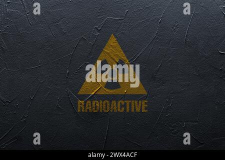 Radioactive sign on black textured wall. Hazard symbol Stock Photo