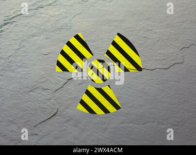 Radioactive sign on light stone wall. Hazard symbol Stock Photo
