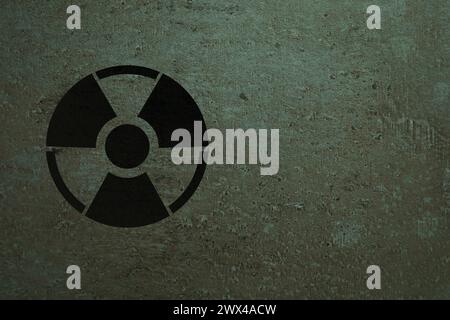 Radioactive sign on stone wall, space for text. Hazard symbol Stock Photo