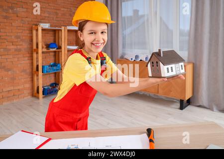 Little architect with house model in room Stock Photo