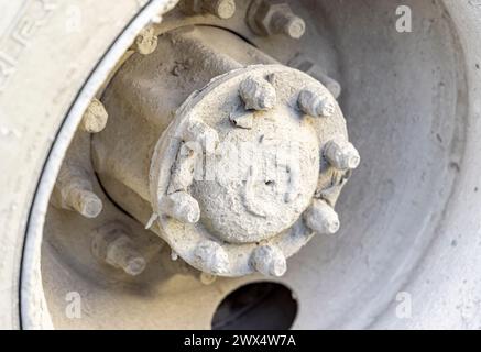 detail of a cement covered wheel on a cement mixer Stock Photo