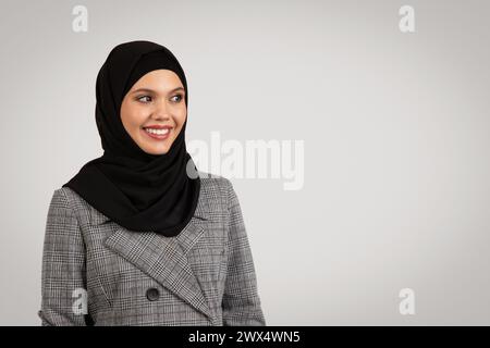 Smiling professional woman in hijab and plaid suit Stock Photo
