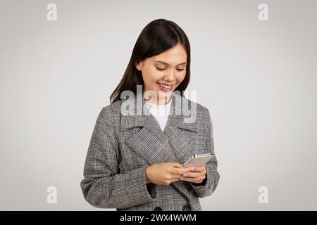 Focused businesswoman texting on smartphone, chatting with client Stock Photo