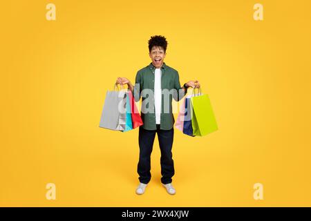 Young man with shopping bags excited Stock Photo