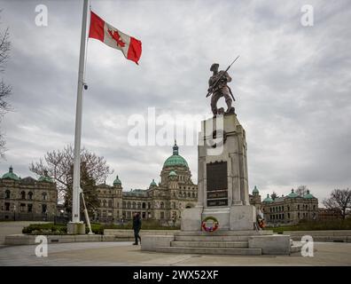 The war memorial statue at the Parliament Buildings seen on an overcast winter day with flag flying at half mast after the death of former PM Mulroney. Stock Photo