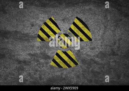Radioactive sign on grey stone wall. Hazard symbol Stock Photo