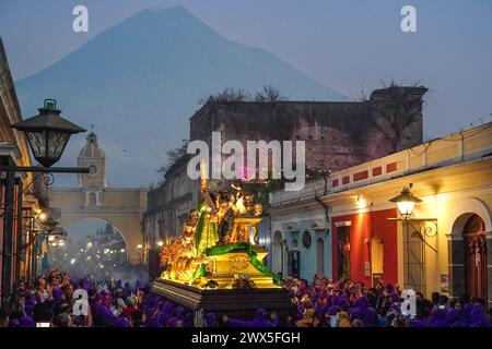 Antigua, Guatemala. 27th Mar, 2024. Costaleros carry the massive Jesús Nazareno del Milagro processional float through the streets during the traditional Santa Semana celebrating Holy Week, March 27, 2024 in Antigua, Guatemala. The opulent processions, detailed alfombras and centuries-old traditions attract more than 1 million people to the ancient capital city. Credit: Richard Ellis/Richard Ellis/Alamy Live News Stock Photo