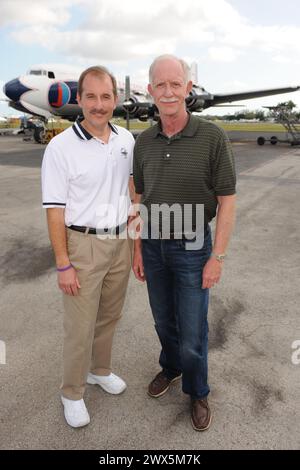 MIAMI, FL - NOVEMBER 17: Captain 'Sully' Sullenberger and Co-pilot Jeff Skiles pose with the Historical 1958 DC7 for a benefit hosted by Historical Flight Foundation. Chesley Burnett 'Sully' Sullenberger, III (born January 23, 1951) is a retired airline captain and aviation safety consultant. He was hailed as a national hero in the United States when he successfully executed an emergency water landing of US Airways Flight 1549 in the Hudson River off Manhattan, New York City, after the aircraft was disabled by striking a flock of Canada geese during its initial climb out of LaGuardia Airport o Stock Photo