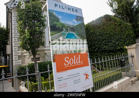 Annandale Sydney, detached victorian home with swimming pool sold by Pilcher estate agents, marketing board feed to metal railings, Sydney,Australia Stock Photo