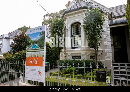 Annandale Sydney, detached victorian home with swimming pool sold by Pilcher estate agents, marketing board feed to metal railings, Sydney,Australia Stock Photo