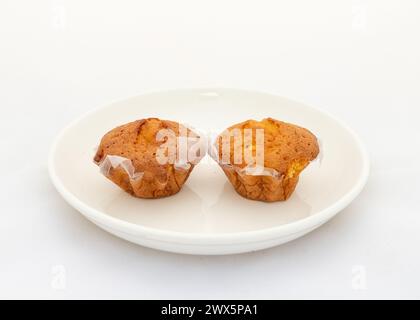 Two cupcakes in plate for breakfast on white background Stock Photo