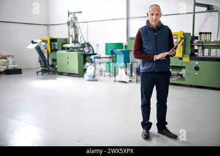 Man, confident and manager of warehouse with clipboard for stock taking in manufacturing, distribution and package for supplier. Portrait, mature and Stock Photo