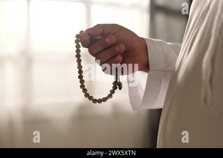 Closeup of unrecognizable Muslim man holding misbaha beads in hand, copy space Stock Photo