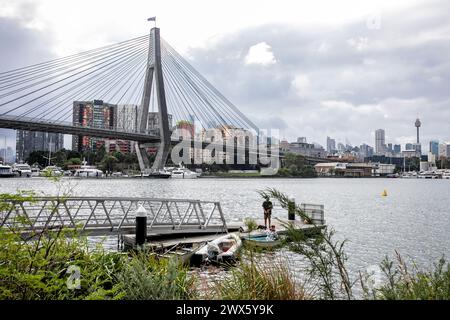 Blackwattle Bay park and pontoon with view of Anzac Bridge cables and pylons and Sydney city centre and tower, NSW,Australia,2024 Stock Photo