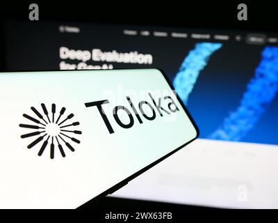 Mobile phone with logo of artificial intelligence company Toloka AI BV in front of business website. Focus on center of phone display. Stock Photo