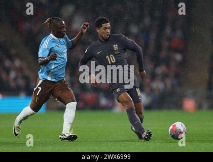 London, UK. 26th Mar, 2024. Jude Bellingham of England is challenged by Jeremy Doku of Belgium during the International Friendly match at Wembley Stadium, London. Picture credit should read: Paul Terry/Sportimage Credit: Sportimage Ltd/Alamy Live News Stock Photo