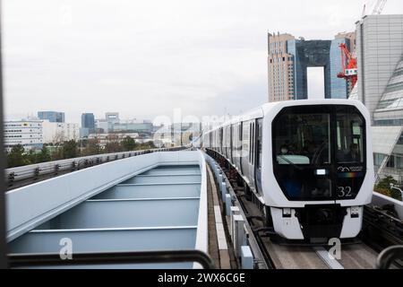 Tokyo, Japan. 28th Mar, 2024. The Yurikamome-sen train line arriving at Tokyo Big Sight Station. The rubber tyre automated metro system moves passengers across the Rainbow Bridge from Shimbashi to Toyosu around the futuristic island neighborhood of Odaiba. Yurikamome-sen serves important destinations such as the Tokyo International Cruise Terminal, Ariake, the Tokyo International Convention Center and Shimbashi.The Yurikamome-sen train line arriving at Tokyo Big Sight Station. The rubber tyre automated metro system moves passengers across the Rainbow Bridge from Shimbashi to Toyosu around t Stock Photo