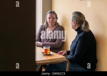 Two women talking while having tea Stock Photo