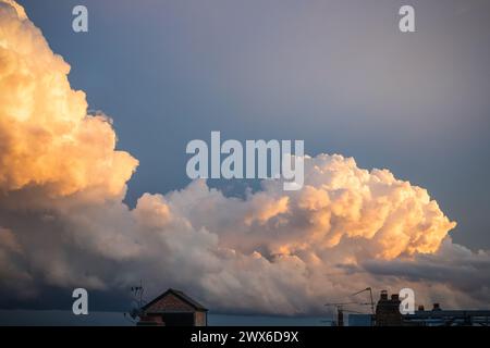 Cloudscape photography, fluffy clouds coloured with sunset light in London Stock Photo