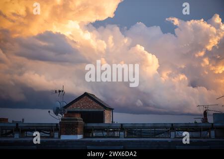 Cloudscape photography, fluffy clouds coloured with sunset light in London Stock Photo