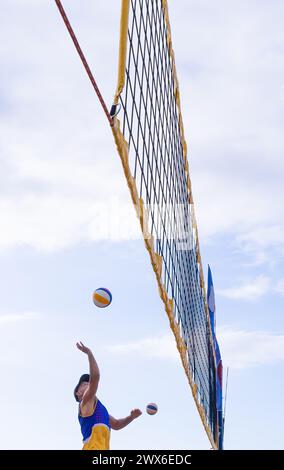 Beach volleyball player hitting the volley ball Stock Photo