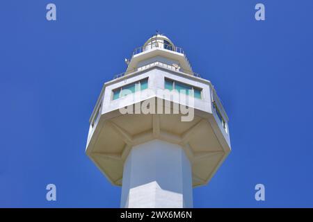 Goseong County, South Korea - July 31, 2019: Looking up from its base, the towering white Daejin Lighthouse reaches into the blue sky, its octagonal s Stock Photo