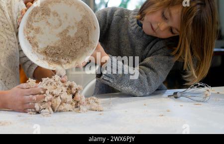 Boy preparing a pizza dough at home Stock Photo