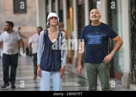 Italian couple in Via Ugo Bassi, Bologna, Italy. Stock Photo