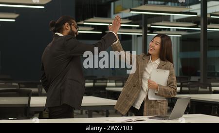 Divers business partners workers multiethnic colleagues Indian man Arabian businessman talk Asian woman employer Korean businesswoman discuss talking Stock Photo