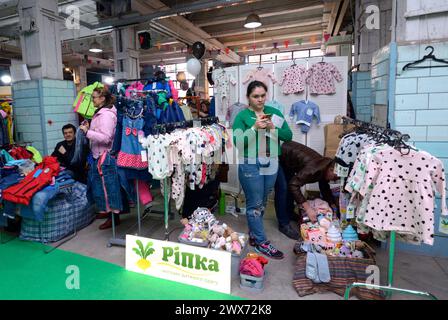 Flea market. Women hoarders standing at the counter selling old clothes and souvenirs. September 26, 2019. Kyiv, Ukraine Stock Photo