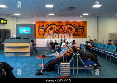 passengers waiting at a airport gate inside vancouver international airport terminal in vancouver, bc, canada Stock Photo