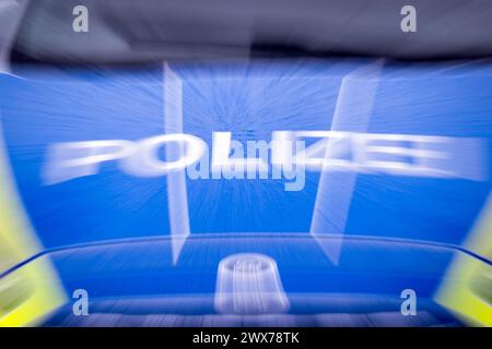 Trebbin, Germany. 22nd Mar, 2024. The word 'police' on the hood of a car, taken during a traffic check on Berliner Straße (zoomed-in image). Credit: Soeren Stache/dpa/Alamy Live News Stock Photo