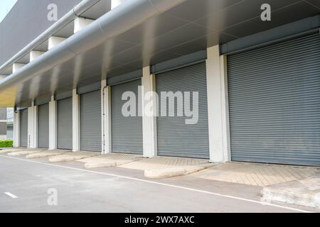 Steel metal doors, roller shutter door in warehouse building. Stock Photo