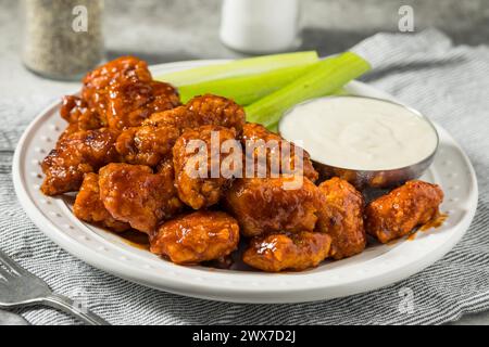 Spicy Boneless Barbecue Chicken Wings with Ranch and Celery Stock Photo