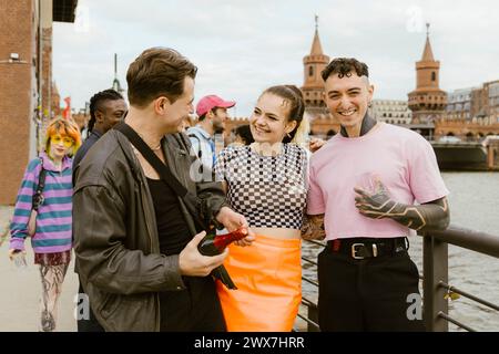 Cheerful non-binary friends enjoying and having fun in city Stock Photo