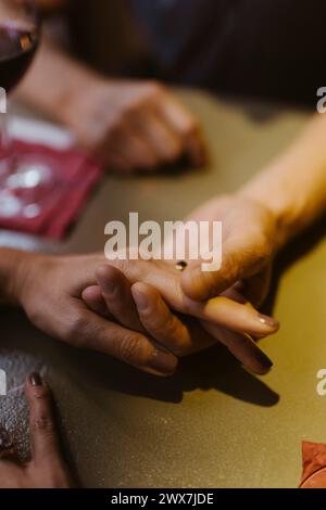 High angle view of mature couple holding hands at restaurant Stock Photo
