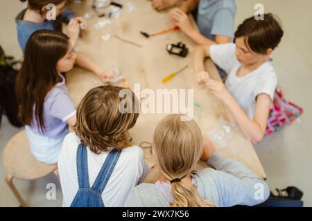 High angle view of male and female students working on robotics project at school Stock Photo