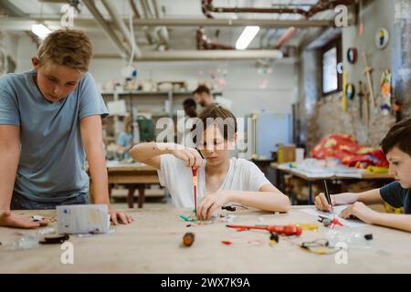 Boys working on robotics project in workshop at school Stock Photo