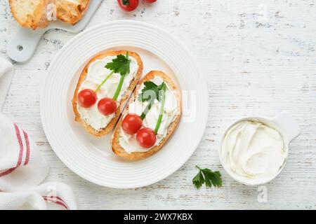 Funny toast in shape of ripe cherries sandwich with cream cheese, bread, cherry tomato, onion and parsley. Food art idea for kids food. Creative break Stock Photo