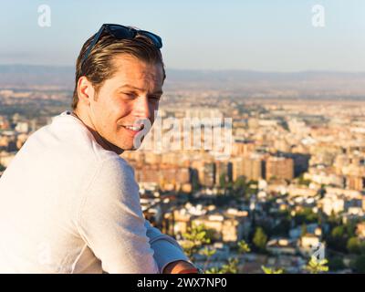 Thoughtful man in his thirties looking down at a panoramic view of the city Stock Photo