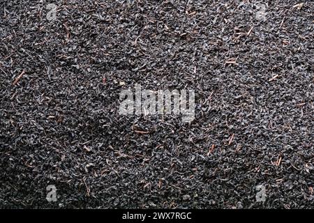 Dried Ceylon blend tea leaves close-up as background. Stock Photo