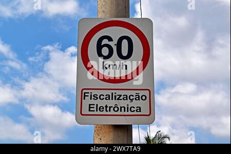 Traffic sign speed limit at 60 kilometers per hour and information in portuguese saying: electronic inspection Stock Photo