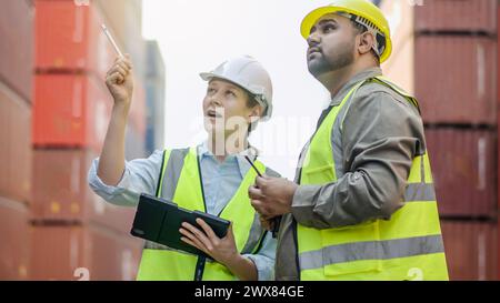 Two workers inspecting near a container Stock Photo